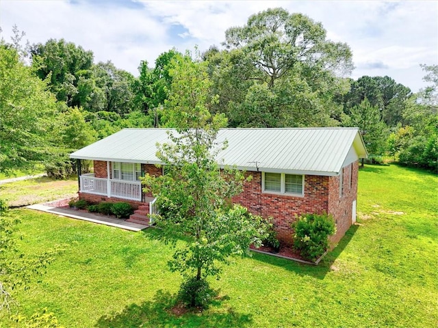 440 Cooley Bridge Rd, Pelzer, SC 29669 - ranch-style home with brick siding, a front lawn, a porch, and a view of trees
