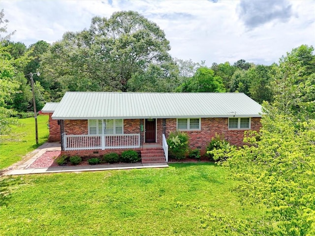 440 Cooley Bridge Rd, Pelzer, SC 29669 - ranch-style house featuring covered porch, a front yard, brick siding, and a metal roof