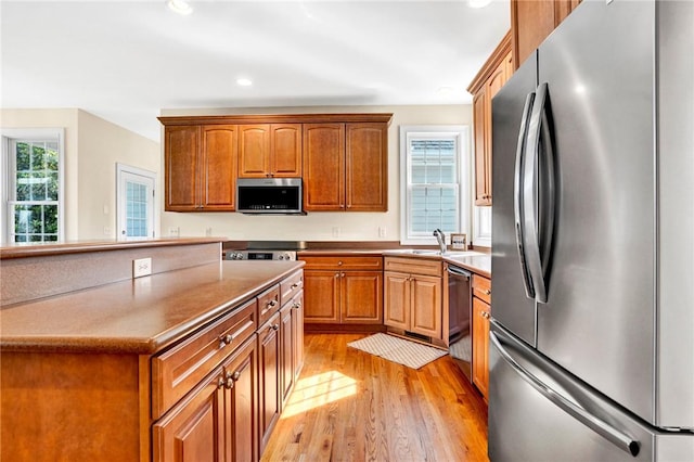 10 Laurelcrest Ln, Travelers Rest, SC 29690 - kitchen with appliances with stainless steel finishes, light wood-style flooring, brown cabinetry, and recessed lighting