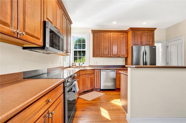10 Laurelcrest Ln, Travelers Rest, SC 29690 - kitchen with stainless steel appliances, light wood finished floors, brown cabinets, and recessed lighting