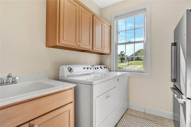 10 Laurelcrest Ln, Travelers Rest, SC 29690 - laundry room featuring washer and dryer, healthy amount of natural light, cabinet space, and light tile patterned floors