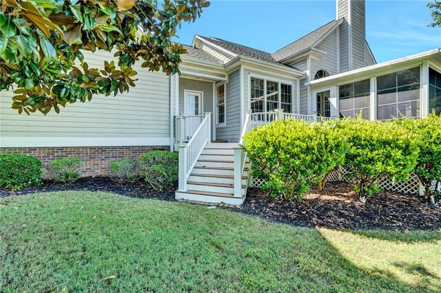 10 Laurelcrest Ln, Travelers Rest, SC 29690 - view of exterior entry featuring a yard and a chimney