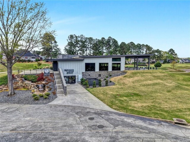 10 Laurelcrest Ln, Travelers Rest, SC 29690 - view of front of house featuring stairs, a front lawn, driveway, and board and batten siding