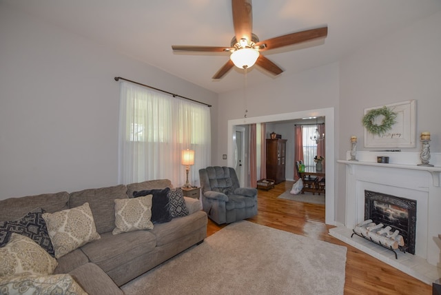 102 Langely St, Abbeville, SC 29620 - living area with wood finished floors, ceiling fan, and a fireplace with raised hearth