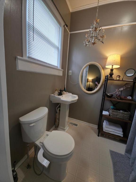 102 Langely St, Abbeville, SC 29620 - half bath with toilet and a chandelier