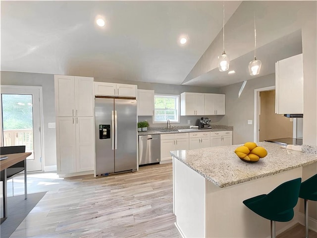 325 Code Cir, Seneca, SC 29678 - kitchen with stainless steel appliances, vaulted ceiling, white cabinets, a peninsula, and light wood finished floors