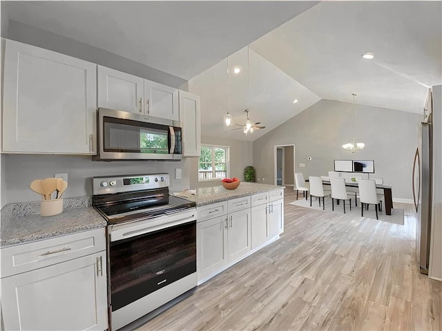 325 Code Cir, Seneca, SC 29678 - kitchen with stainless steel appliances, white cabinets, vaulted ceiling, light wood finished floors, and hanging light fixtures