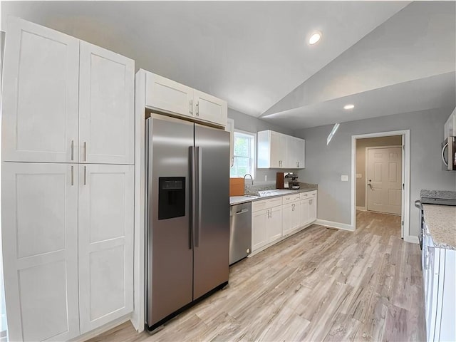 325 Code Cir, Seneca, SC 29678 - kitchen with appliances with stainless steel finishes, vaulted ceiling, white cabinets, light wood-type flooring, and recessed lighting