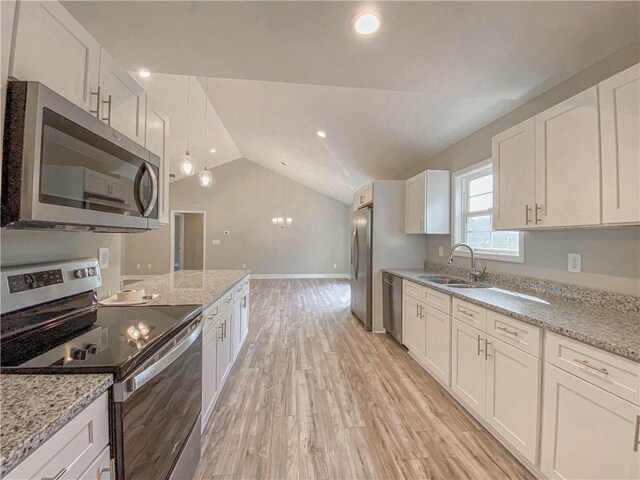 325 Code Cir, Seneca, SC 29678 - kitchen featuring stainless steel appliances, lofted ceiling, white cabinetry, light stone counters, and light wood-style flooring