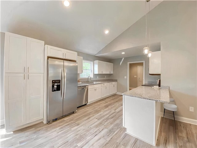 325 Code Cir, Seneca, SC 29678 - kitchen with appliances with stainless steel finishes, white cabinets, light wood finished floors, a peninsula, and vaulted ceiling