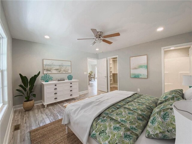 325 Code Cir, Seneca, SC 29678 - bedroom with light wood finished floors, recessed lighting, a ceiling fan, a spacious closet, and ensuite bath