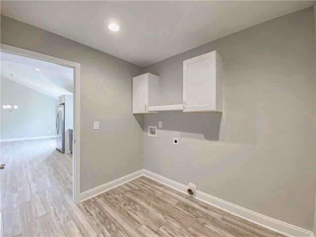 325 Code Cir, Seneca, SC 29678 - washroom featuring hookup for an electric dryer, light wood finished floors, washer hookup, cabinet space, and a chandelier