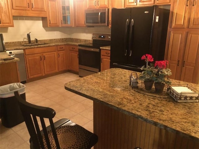 431 Seigler Rd, Iva, SC 29655 - kitchen featuring appliances with stainless steel finishes, stone countertops, brown cabinets, and glass insert cabinets