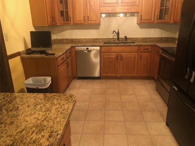 431 Seigler Rd, Iva, SC 29655 - kitchen featuring stainless steel appliances, dark stone counters, brown cabinetry, and glass insert cabinets