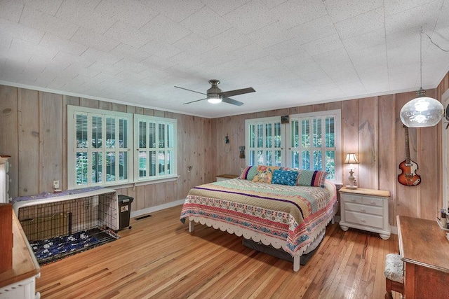 197 Jubie Ln, Seneca, SC 29672 - bedroom with wood-type flooring, wooden walls, a ceiling fan, and crown molding