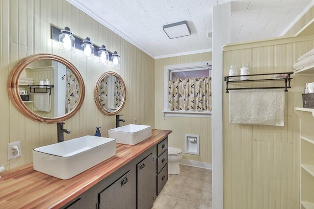 197 Jubie Ln, Seneca, SC 29672 - bathroom featuring ornamental molding, double vanity, tile patterned floors, and wood walls
