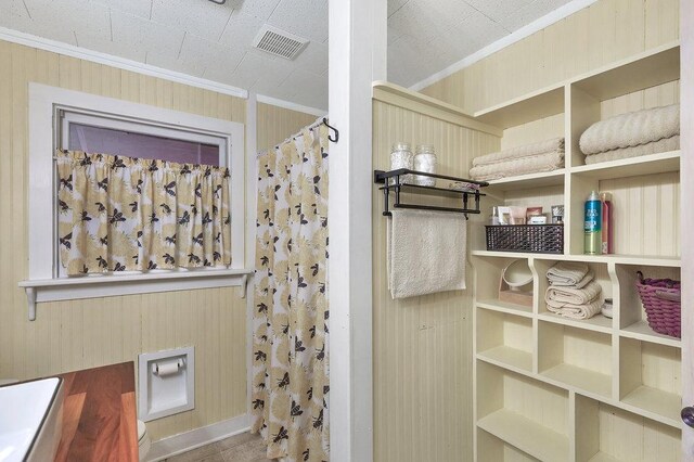 197 Jubie Ln, Seneca, SC 29672 - bathroom featuring crown molding, a shower with shower curtain, and wood walls