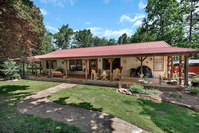 197 Jubie Ln, Seneca, SC 29672 - rear view of property featuring a metal roof, a lawn, board and batten siding, and covered porch