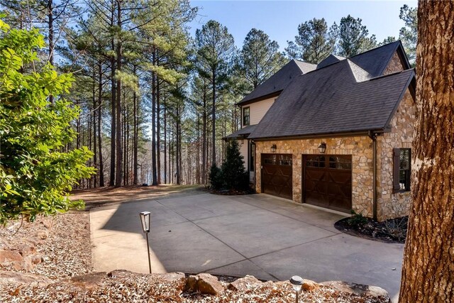 703 Timberbrook Trl, Salem, SC 29676 - view of home's exterior featuring stone siding, roof with shingles, and driveway