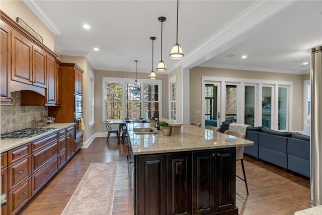 703 Timberbrook Trl, Salem, SC 29676 - kitchen with stainless steel appliances, a kitchen breakfast bar, decorative backsplash, ornamental molding, and a center island with sink