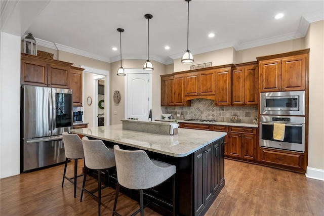 703 Timberbrook Trl, Salem, SC 29676 - kitchen with stainless steel appliances, dark wood-style flooring, an island with sink, decorative backsplash, and light stone counters