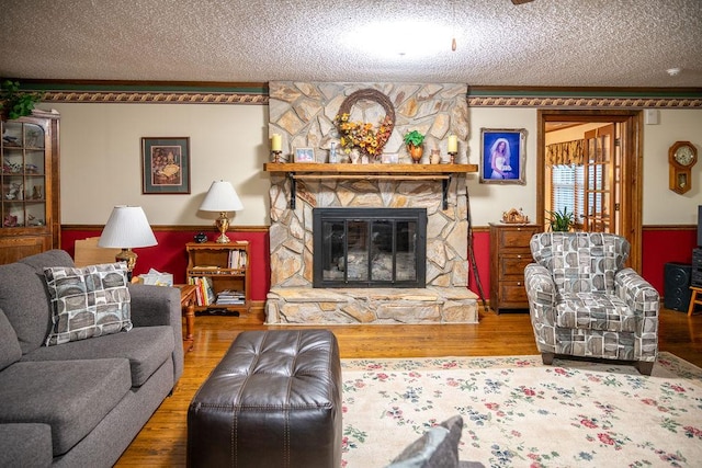 316 Brewer Rd, Walhalla, SC 29691 - living room with a textured ceiling, wood finished floors, a fireplace, a wainscoted wall, and crown molding