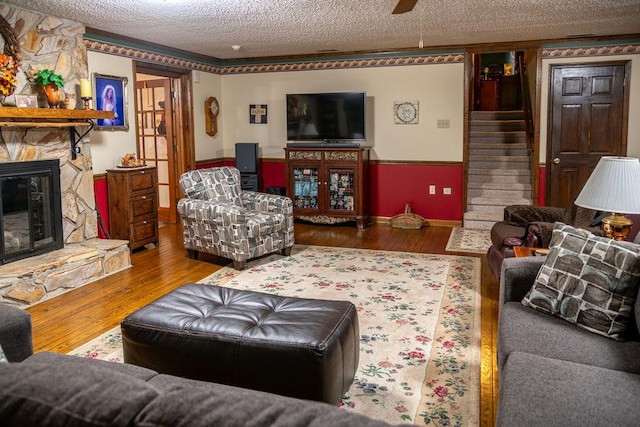 316 Brewer Rd, Walhalla, SC 29691 - living area with a textured ceiling, a stone fireplace, wood finished floors, and stairway