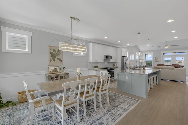 914 Blue Moon St, Taylors, SC 29687 - dining area with light wood-style floors, wainscoting, a ceiling fan, ornamental molding, and recessed lighting