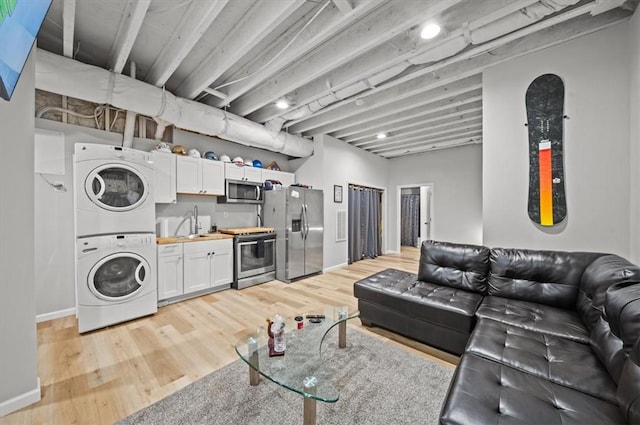 213 Redbud St, Seneca, SC 29672 - living area featuring stacked washer / drying machine, light wood-style floors, and bar area