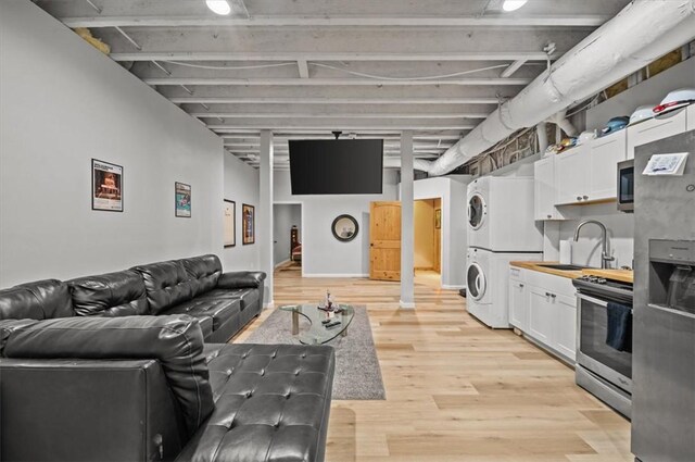 213 Redbud St, Seneca, SC 29672 - living area with stacked washer / dryer and light wood-style floors