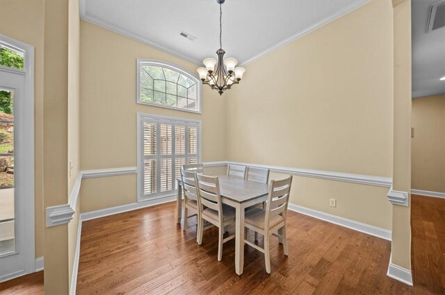213 Redbud St, Seneca, SC 29672 - dining room with a chandelier, plenty of natural light, wood finished floors, and ornamental molding