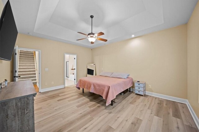 213 Redbud St, Seneca, SC 29672 - bedroom with a tray ceiling, light wood-style flooring, ceiling fan, and ensuite bathroom