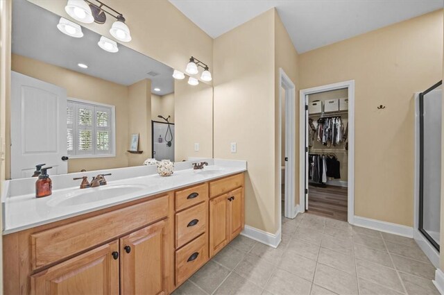 213 Redbud St, Seneca, SC 29672 - bathroom with a stall shower, double vanity, tile patterned flooring, and a walk in closet