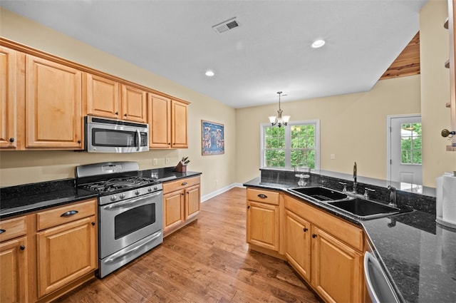 213 Redbud St, Seneca, SC 29672 - kitchen featuring appliances with stainless steel finishes, light wood-style flooring, a chandelier, recessed lighting, and dark stone countertops