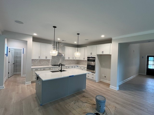109 Sunrise Ct Unit Sun0005, Anderson, SC 29625 - kitchen with white cabinetry, backsplash, light countertops, a center island with sink, and pendant lighting