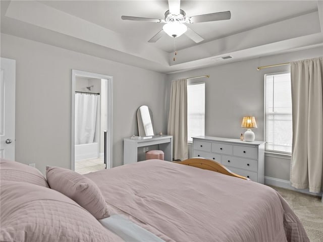 112 Wilbur St, Easley, SC 29640 - bedroom with light colored carpet, a raised ceiling, ensuite bath, and a ceiling fan