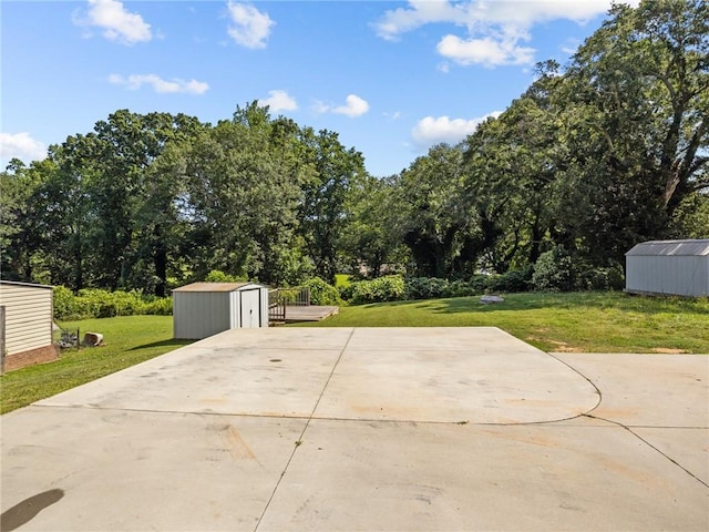 112 Wilbur St, Easley, SC 29640 - view of patio / terrace with a storage unit, concrete driveway, and view of scattered trees