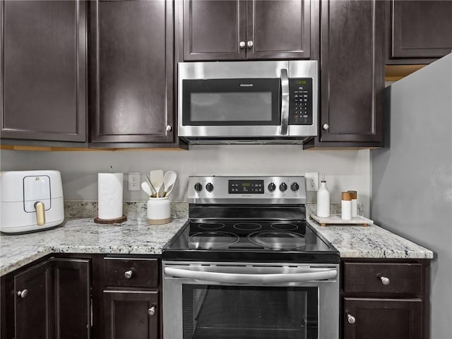 112 Wilbur St, Easley, SC 29640 - kitchen with stainless steel appliances, dark brown cabinets, and light stone counters