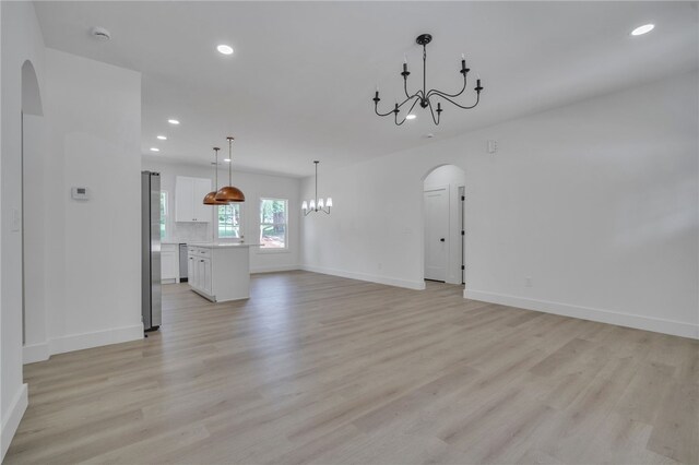 110 Dalton Rd, Seneca, SC 29678 - unfurnished living room featuring arched walkways, a chandelier, recessed lighting, and light wood-style flooring