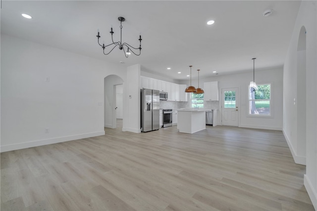 110 Dalton Rd, Seneca, SC 29678 - unfurnished living room with arched walkways, a chandelier, recessed lighting, and light wood-style flooring