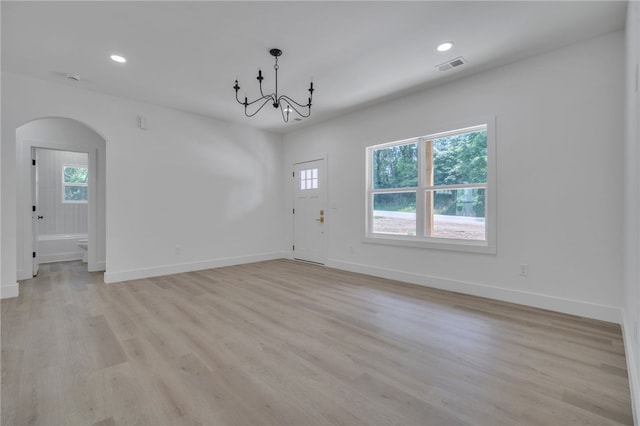 110 Dalton Rd, Seneca, SC 29678 - unfurnished living room featuring arched walkways, a chandelier, light wood-style flooring, and recessed lighting
