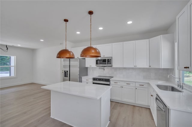 110 Dalton Rd, Seneca, SC 29678 - kitchen featuring stainless steel appliances, light wood-style floors, tasteful backsplash, light countertops, and a kitchen island