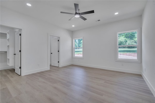 110 Dalton Rd, Seneca, SC 29678 - unfurnished bedroom with multiple windows, a spacious closet, light wood finished floors, recessed lighting, and ceiling fan