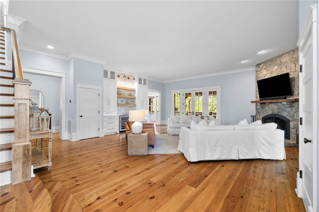 129 N Lawn Dr, Sunset, SC 29685 - living area featuring beverage cooler, a stone fireplace, light wood finished floors, crown molding, and stairway