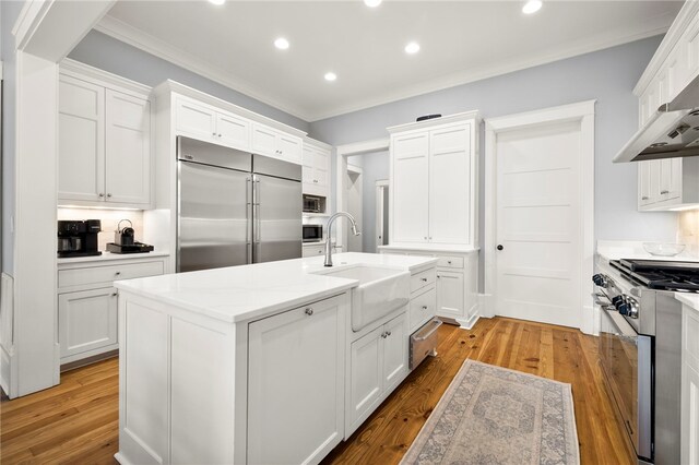 129 N Lawn Dr, Sunset, SC 29685 - kitchen featuring premium appliances, light wood-type flooring, recessed lighting, crown molding, and white cabinets