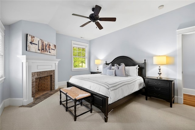 129 N Lawn Dr, Sunset, SC 29685 - bedroom with a ceiling fan, a brick fireplace, and wood finished floors