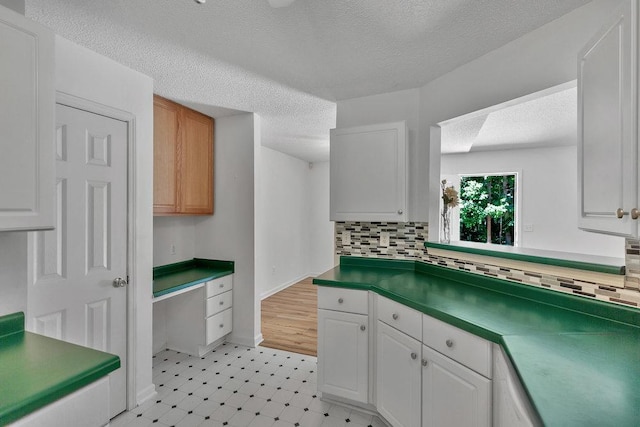 433 Den Ridge Dr, Walhalla, SC 29691 - kitchen featuring backsplash, a textured ceiling, white cabinetry, and light floors