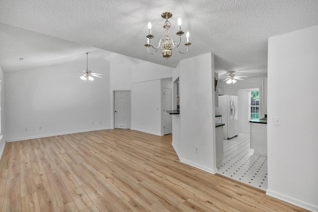 433 Den Ridge Dr, Walhalla, SC 29691 - unfurnished living room featuring ceiling fan, light wood-style floors, a textured ceiling, lofted ceiling, and a chandelier