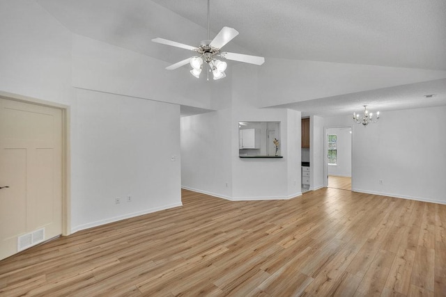 433 Den Ridge Dr, Walhalla, SC 29691 - unfurnished living room with high vaulted ceiling, a chandelier, light wood-style floors, and a ceiling fan