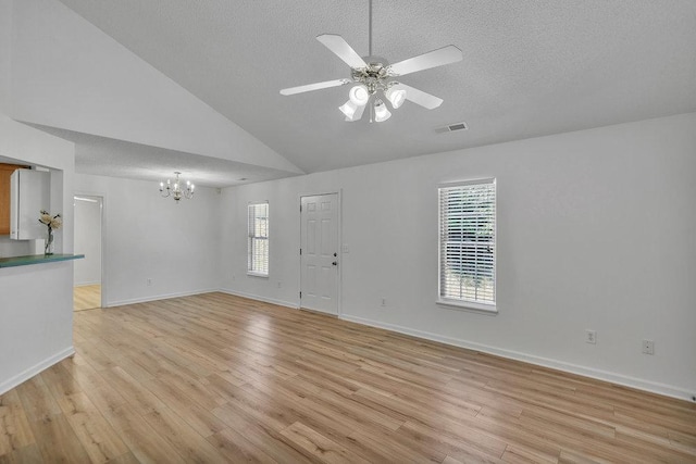 433 Den Ridge Dr, Walhalla, SC 29691 - unfurnished living room with a chandelier, a textured ceiling, light wood-style flooring, ceiling fan, and high vaulted ceiling